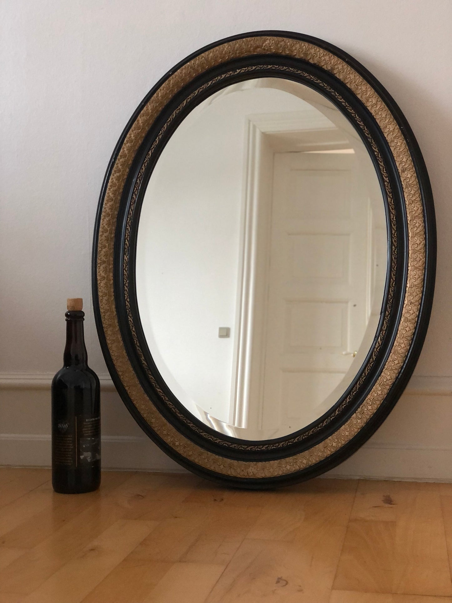 Antique Carved Louis Philippe Oval Mirror In Black and Gold France Late 19th Century