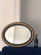 Antique Carved Louis Philippe Oval Mirror In Black and Gold France Late 19th Century